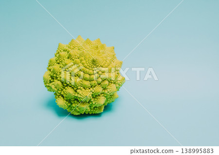 Fresh Romanesque cabbage on a blue pastel background. Fresh Romanesque cabbage on a blue pastel background. 138995883