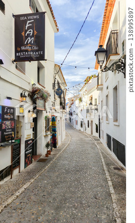 Exploring Altea's charming old town street, a picturesque Spanish village perfect for memorable family holidays and vacation trips Exploring Altea's charming old town street, a picturesque Spanish village perfect for memorable family holidays and vacation trips 138995897