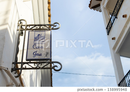 Street sign in Altea, Spain showing Carrer Jesus and city details, inviting tourists to explore old town charm during family holidays Street sign in Altea, Spain showing Carrer Jesus and city details, inviting tourists to explore old town charm during family holidays 138995948