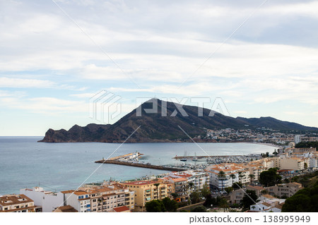 Altea city vista in Spain revealing a scenic bay, a lively marina dotted with boats, numerous coastal buildings 138995949