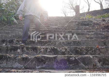 A child (faceless) descending a steep stone staircase. A child (faceless) descending a steep stone staircase. 138996705