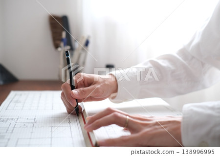A Japanese architect drawing architectural plans A Japanese architect drawing architectural plans 138996995