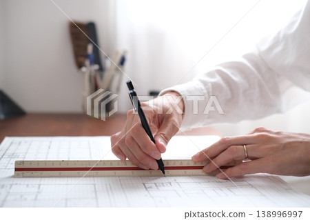 A Japanese architect drawing architectural plans A Japanese architect drawing architectural plans 138996997