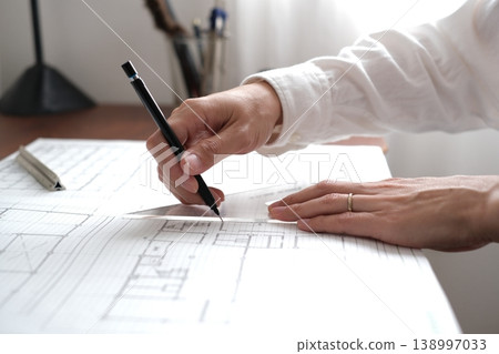 A Japanese architect drawing architectural plans A Japanese architect drawing architectural plans 138997033