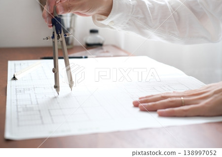 A Japanese architect drawing architectural plans A Japanese architect drawing architectural plans 138997052