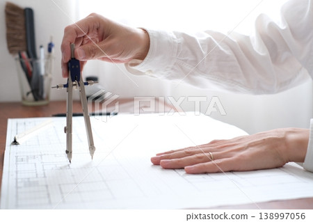 A Japanese architect drawing architectural plans A Japanese architect drawing architectural plans 138997056