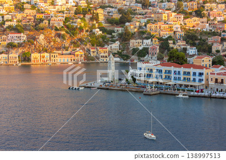 Harbor view with clock tower and hillside houses in Symi, Greece Harbor view with clock tower and hillside houses in Symi, Greece 138997513