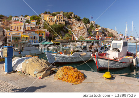 Sailboats in harbor with hillside houses in Symi, Greece Sailboats in harbor with hillside houses in Symi, Greece 138997529