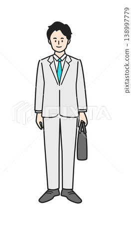 A man wearing a suit and carrying a bag. A man wearing a suit and carrying a bag. 138997779