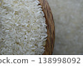 Raw rice in wooden bowl on a blur background. 138998092