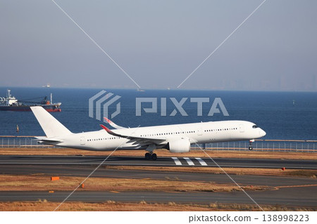 A passenger plane taking off from the runway at Haneda Airport. A passenger plane taking off from the runway at Haneda Airport. 138998223
