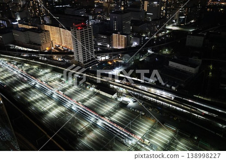 A sleeper express train parked at the train depot in Shinagawa at night. A sleeper express train parked at the train depot in Shinagawa at night. 138998227