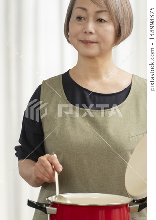 Senior woman making vegetable broth in the kitchen 138998375