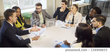 Diverse business team in office meeting discussing strategy and project plans Diverse business team in office meeting discussing strategy and project plans 138998655