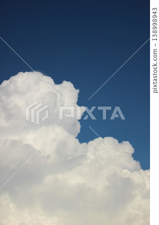 A summer landscape of blue skies and white cumulonimbus clouds. 138998943