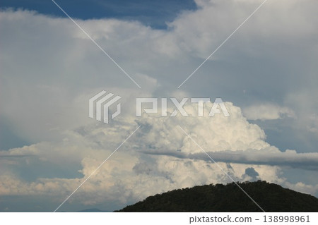 A summer landscape of blue skies and white cumulonimbus clouds. 138998961