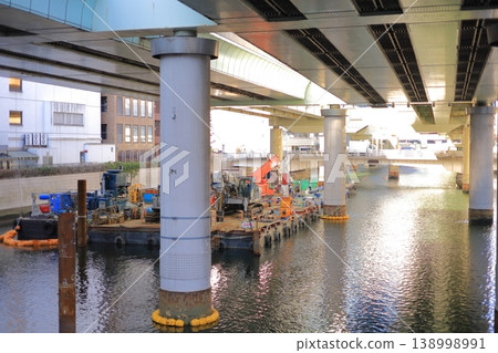 Highway under construction over a city river Highway under construction over a city river 138998991