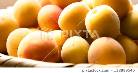 An image of many green plums piled in a bush to make pickled plums. An image of many green plums piled in a bush to make pickled plums. 138999540