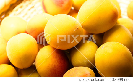 An image of many green plums piled in a bush to make pickled plums. An image of many green plums piled in a bush to make pickled plums. 138999554