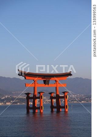 The Great Torii Gate of Itsukushima Shrine standing in the sea at Miyajima, Hatsukaichi City, Hiroshima Prefecture, and the rising sun. 138999563