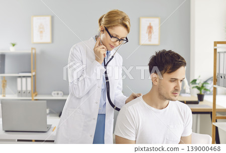 Male patient sitting in exam room in clinic for a medical checkup. Medicine concept. Male patient sitting in exam room in clinic for a medical checkup. Medicine concept. 139000468