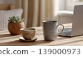 Coffee ceramic mug laptop succulent wooden table home office soft light morning workspace minimalist coffee cup and ceramic mug near laptop and succulent wooden table home office, soft morning 139000973