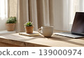 Home office laptop coffee cup wooden table succulent notebook window light minimalist workspace morning routine Modern home office workspace with laptop, coffee cup, succulent, notebook wooden 139000974
