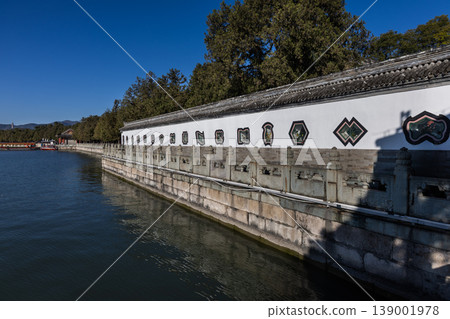 Corridor within Summer Palace next to Kunming lake in Beijing, with windows in multiple shape being one of tourist attractions. Corridor within Summer Palace next to Kunming lake in Beijing, with windows in multiple shape being one of tourist attractions. 139001978