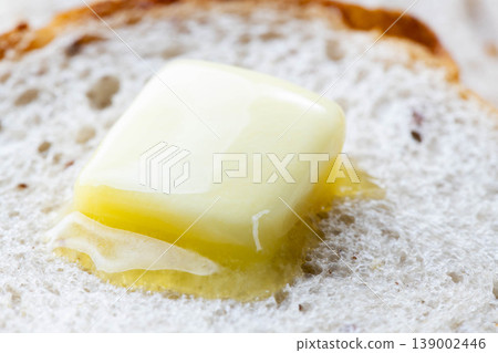 The scene of butter melting on bread. The scene of butter melting on bread. 139002446
