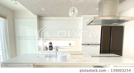 A minimalist, modern kitchen with a white base. A minimalist, modern kitchen with a white base. 139003254
