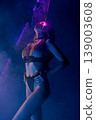 Sensual woman in lingerie under futuristic neon laser light in dark studio 139003608