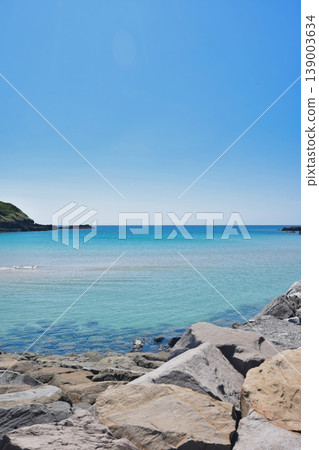 A vertical landscape of a clear sea and blue sky. A vertical landscape of a clear sea and blue sky. 139003634