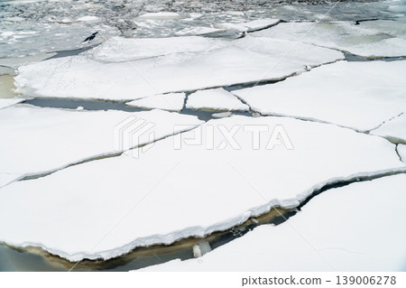 Ice Floes and Broken River Ice Floating on Dark Water in Late Winter Morning Ice Floes and Broken River Ice Floating on Dark Water in Late Winter Morning 139006278