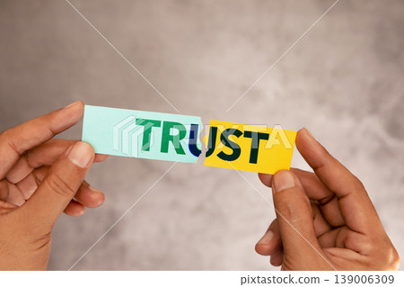 Hands tearing paper with word trust, broken relationship concept, trust issues 139006309