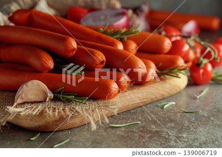 Thin smoked sausages with tomatoes, onion, garlic, and rosemary. Thin smoked sausages with tomatoes, onion, garlic, and rosemary. 139006719