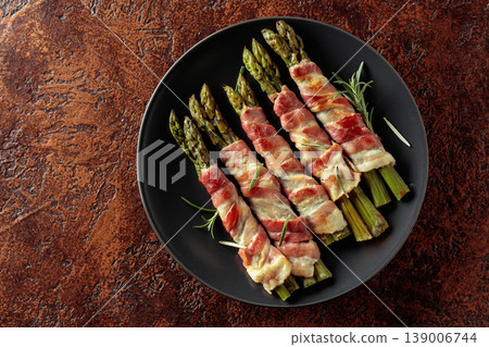Grilled green asparagus wrapped in bacon. Grilled green asparagus wrapped in bacon. 139006744