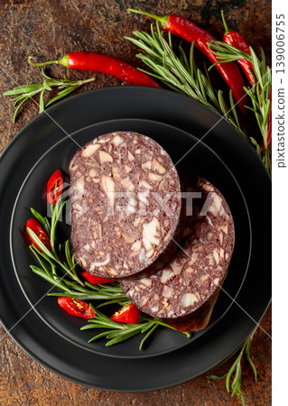 Blood sausage with meat offal accompanied by rosemary and red pepper. 139006755