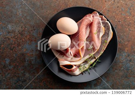 Pork bacon with thyme and eggs. Pork bacon with thyme and eggs. 139006772
