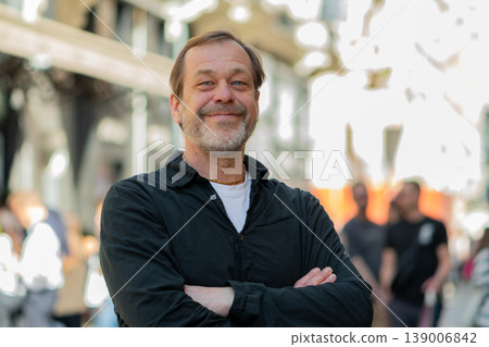 Man 50 years old standing outdoors looking aside with confidence in urban environment Man 50 years old standing outdoors looking aside with confidence in urban environment 139006842