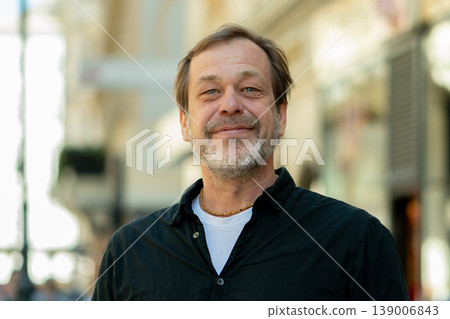 Male portrait in city conveys trust stability and life experience 139006843