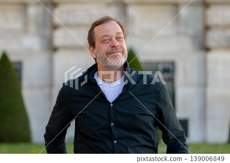 Man 55 years old looking up outdoors with confident expression and ambition for success 139006849