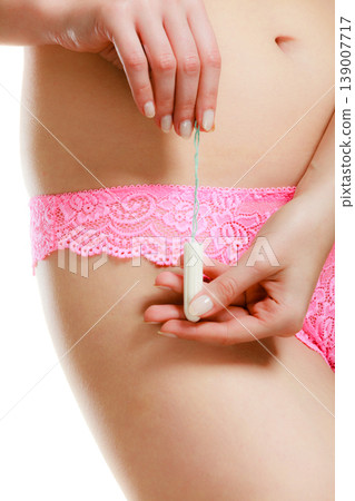 Woman with tampon in monthly cycle. Woman with tampon in monthly cycle. 139007717