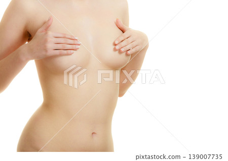 Woman examining her breasts for breast cancer Woman examining her breasts for breast cancer 139007735