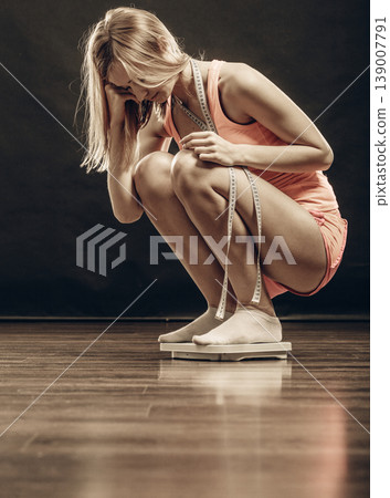 gym woman on weight scale gym woman on weight scale 139007791