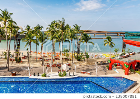 Phu Quoc, Vietnam - January 3 2026: Tropical Resort Poolside View with Palm Trees Phu Quoc, Vietnam - January 3 2026: Tropical Resort Poolside View with Palm Trees 139007881