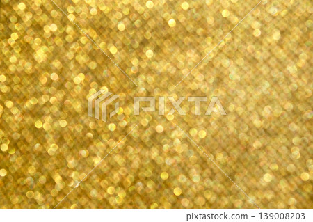 Soft golden bokeh glitter background with warm sparkling lights and festive holiday shimmer Soft golden bokeh glitter background with warm sparkling lights and festive holiday shimmer 139008203