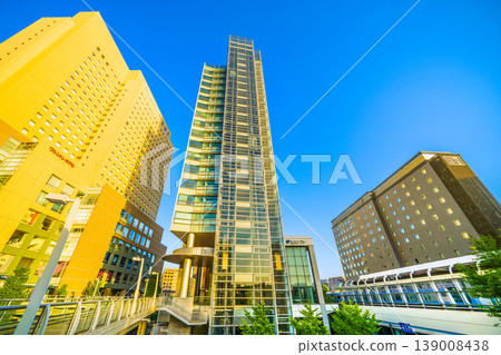 Yokohama cityscape, Japan, April. View from in front of Sakuragicho Station of the Washington Hotel, Fujisoft, H Mets, and trains bathed in the setting sun. Yokohama cityscape, Japan, April. View from in front of Sakuragicho Station of the Washington Hotel, Fujisoft, H Mets, and trains bathed in the setting sun. 139008438