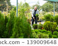 elderly customer purchases plants at an open market 139009648