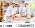 Man and woman, experienced bakers, prepare dough for baguettes and croissants together in private bakery 139009655