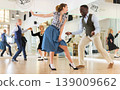 Man and woman performing jazz dance in dancing room 139009662